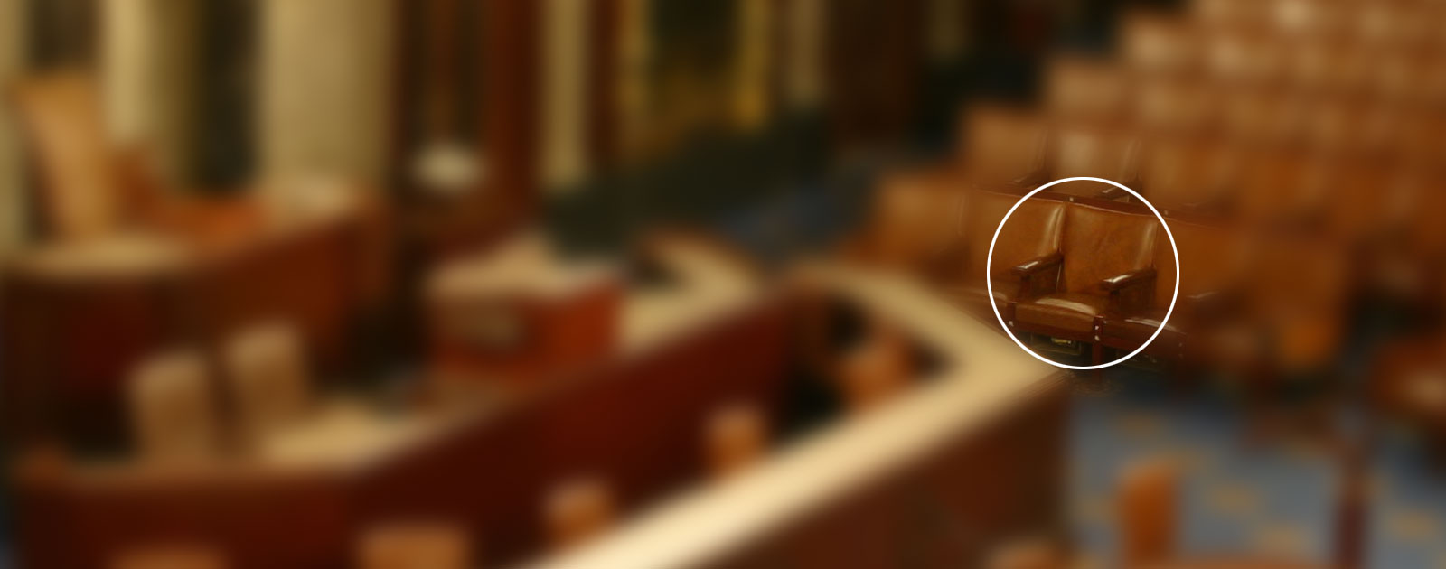 Empty seat is circled among a theater or gallery of seats